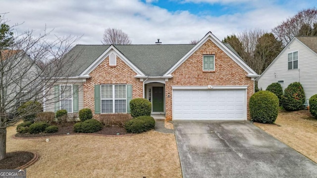 view of front of house featuring a garage, roof with shingles, concrete driveway, and brick siding