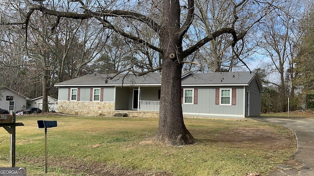 ranch-style house with a porch and a front yard