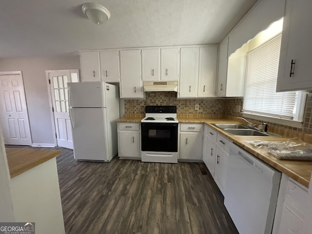 kitchen featuring white appliances, under cabinet range hood, white cabinets, and a sink