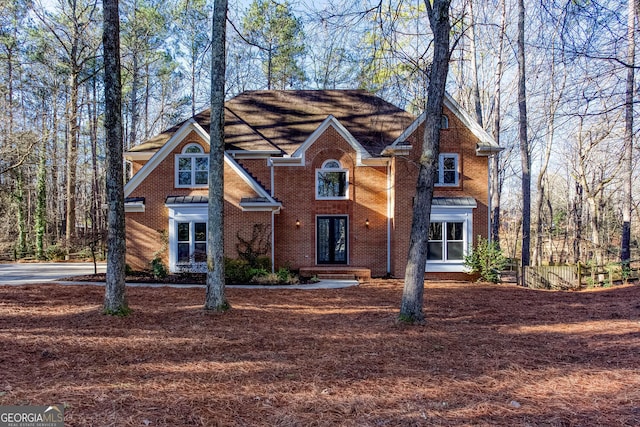 traditional home with french doors and brick siding