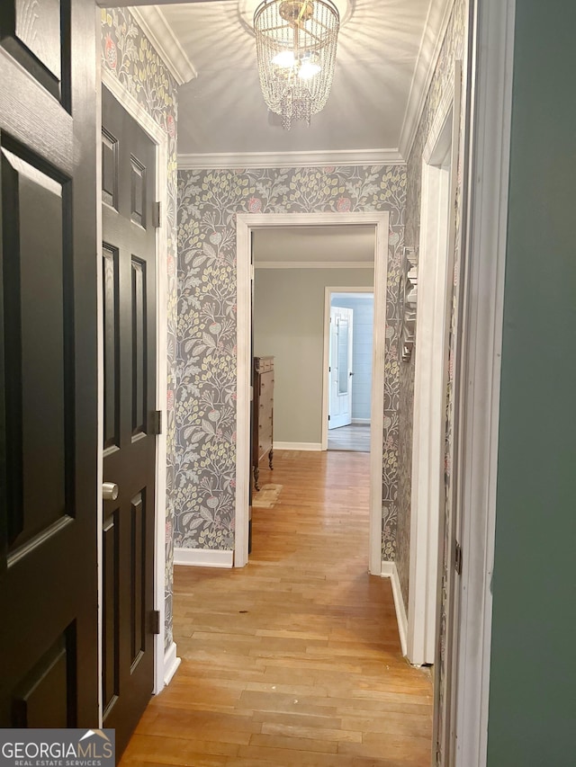 746 Thomas Rd, Trion, GA 30753 - corridor with wallpapered walls, baseboards, light wood finished floors, crown molding, and a chandelier