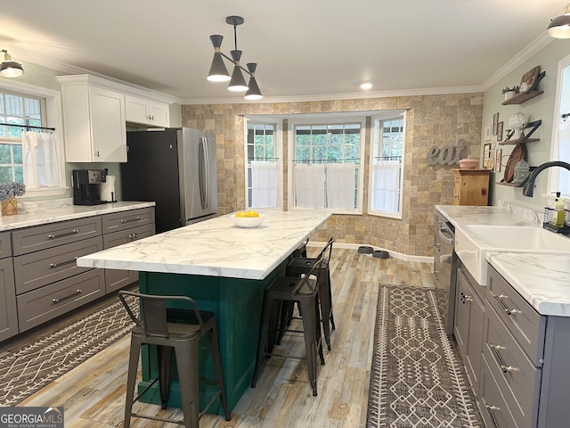 746 Thomas Rd, Trion, GA 30753 - kitchen with a sink, gray cabinetry, light wood-style floors, a breakfast bar area, and a center island