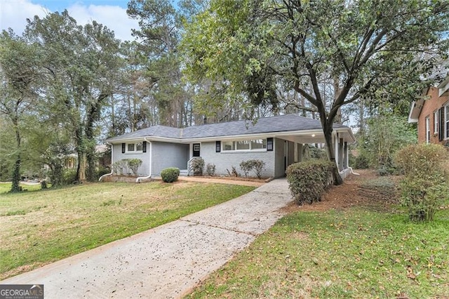 view of front facade with concrete driveway, a carport, and a front yard