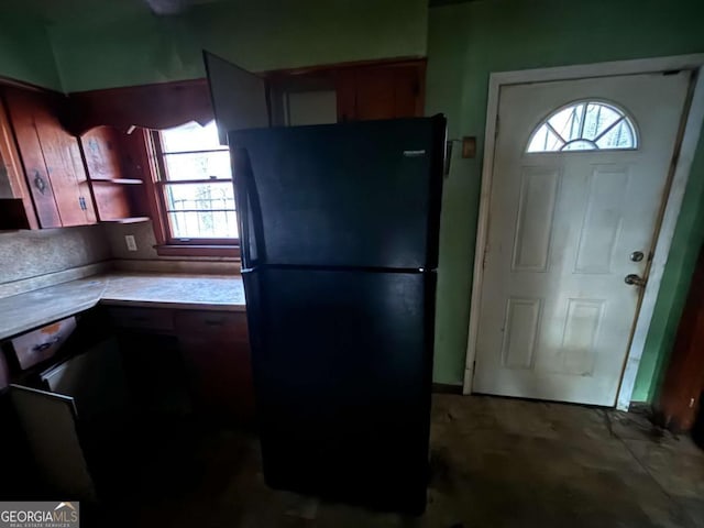 kitchen featuring light countertops and freestanding refrigerator