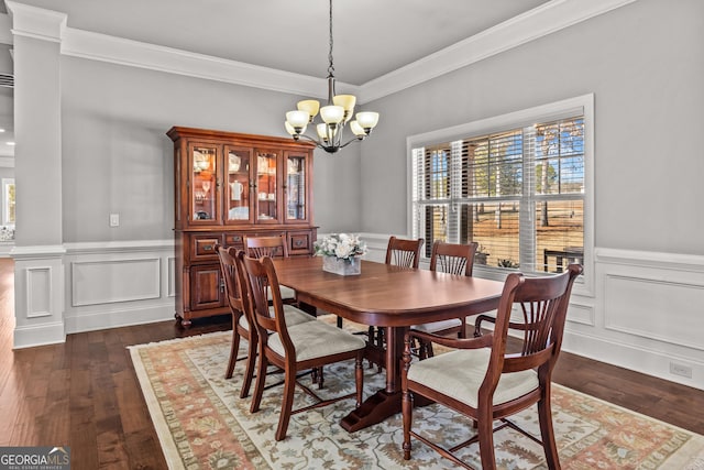 dining area with a notable chandelier, dark wood-type flooring, plenty of natural light, and crown molding