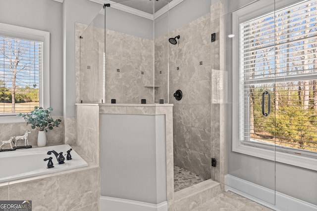 bathroom featuring a garden tub, ornamental molding, a shower stall, and baseboards