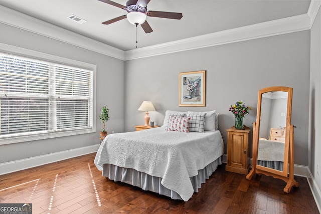 bedroom with baseboards, crown molding, visible vents, and dark wood-type flooring