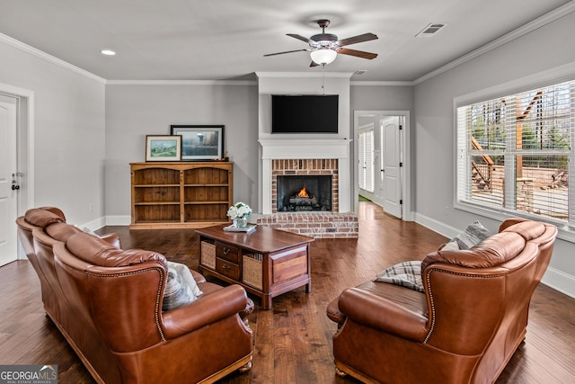 living room with a brick fireplace, wood-type flooring, visible vents, and baseboards