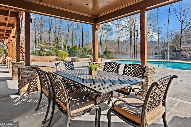 view of patio featuring a fenced backyard, a fenced in pool, and outdoor dining space