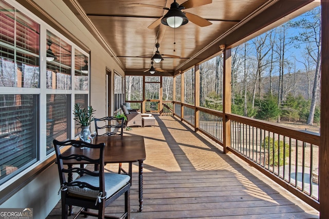 sunroom / solarium with wooden ceiling and ceiling fan