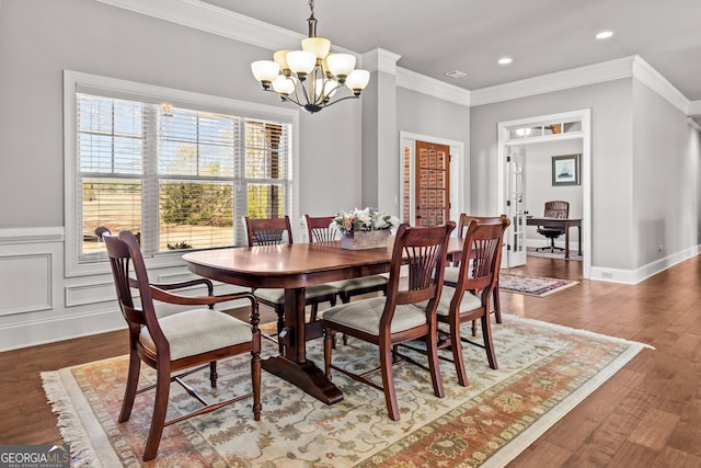 dining space featuring ornamental molding, recessed lighting, hardwood / wood-style flooring, and an inviting chandelier