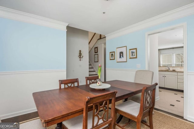 dining area with baseboards, stairway, and crown molding