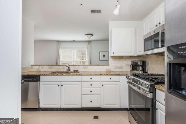 kitchen with white cabinetry, visible vents, appliances with stainless steel finishes, and a sink