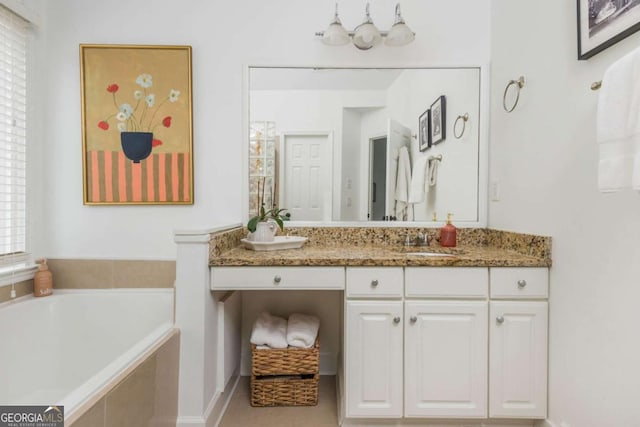 bathroom with vanity and a bath