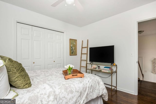 bedroom with a closet, ceiling fan, baseboards, and wood finished floors