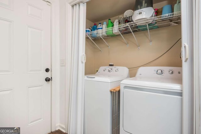 washroom with washing machine and dryer and laundry area