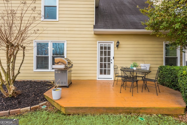 deck featuring outdoor dining area and a grill