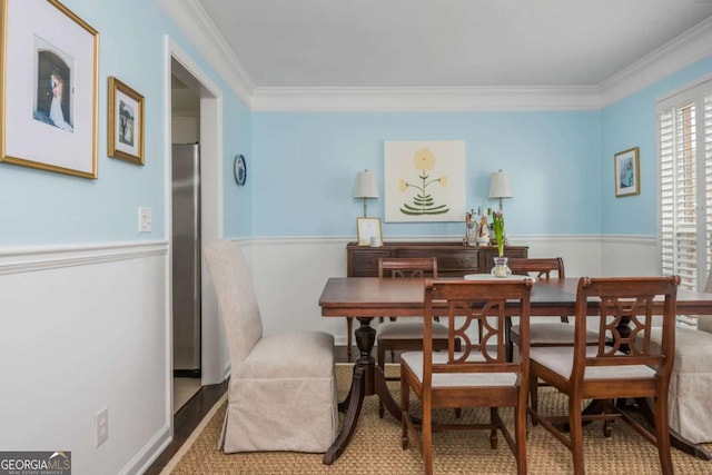 dining room with ornamental molding and wood finished floors