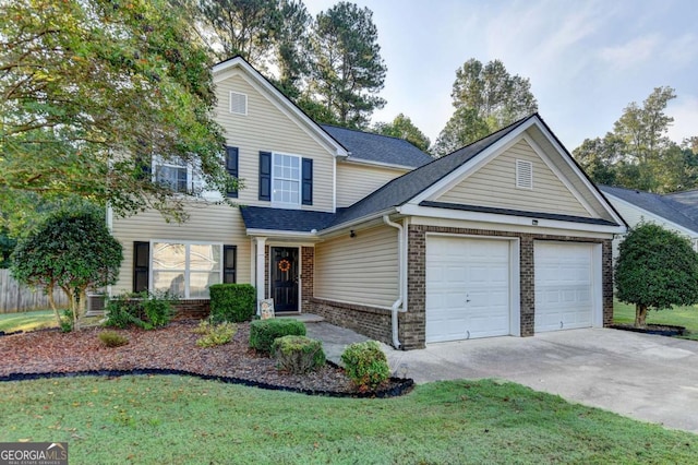 traditional-style home with driveway, brick siding, roof with shingles, an attached garage, and a front yard