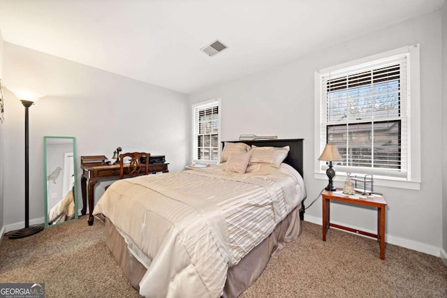 carpeted bedroom with visible vents and baseboards