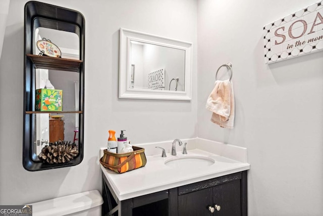 bathroom featuring toilet and vanity