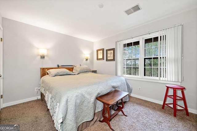 carpeted bedroom with visible vents and baseboards