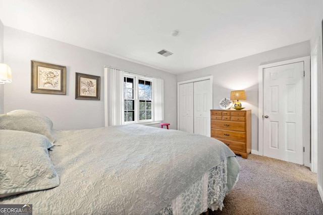 bedroom featuring a closet, visible vents, and carpet flooring