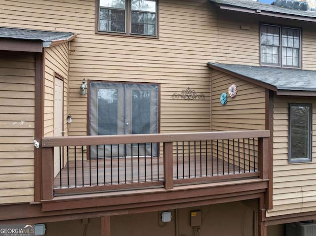 back of property featuring a shingled roof and a balcony