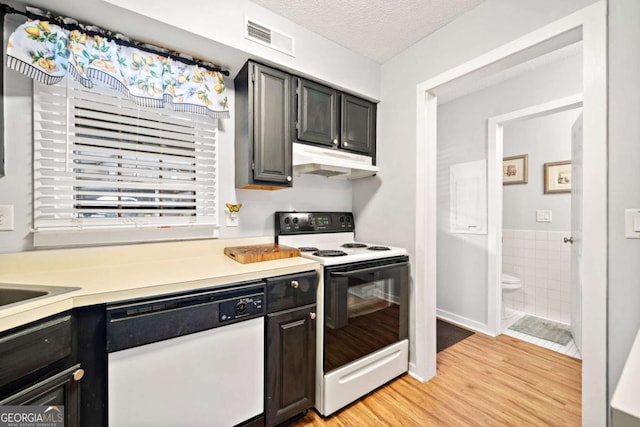 kitchen featuring a textured ceiling, white dishwasher, under cabinet range hood, electric range, and light countertops