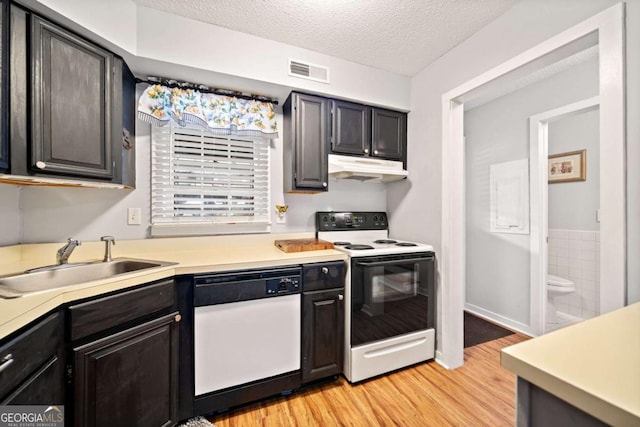 kitchen featuring range with electric stovetop, visible vents, white dishwasher, a sink, and under cabinet range hood