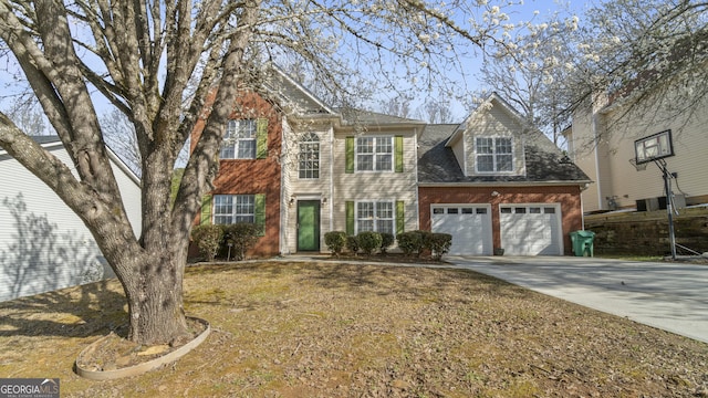 view of front facade featuring a garage, concrete driveway, and brick siding