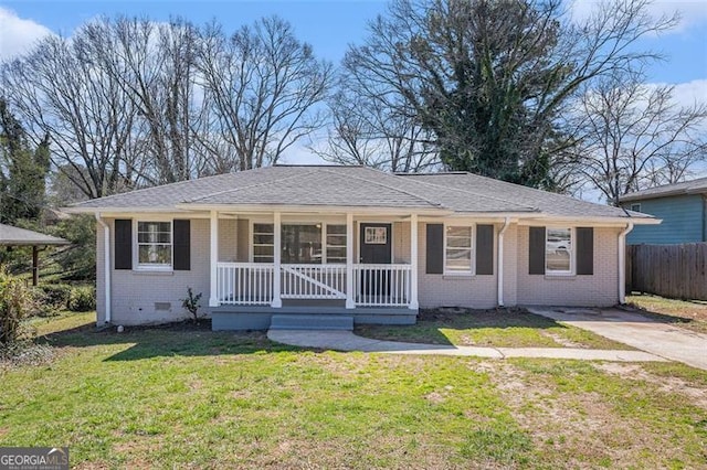 ranch-style home with a porch, brick siding, fence, crawl space, and a front yard