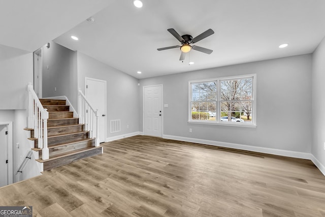 foyer featuring stairs, wood finished floors, visible vents, and baseboards