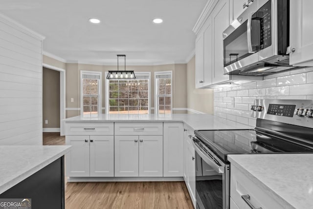 kitchen with stainless steel appliances, light countertops, light wood-style floors, and white cabinetry