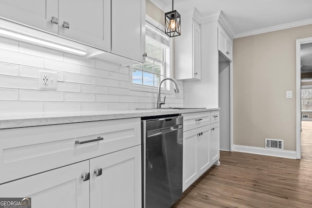 kitchen with crown molding, visible vents, backsplash, stainless steel dishwasher, and a sink