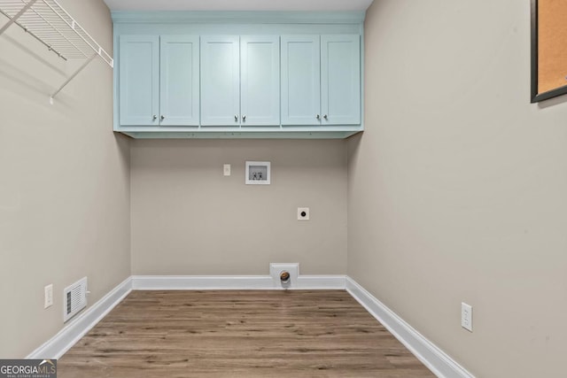 laundry area featuring hookup for a washing machine, cabinet space, baseboards, and hookup for an electric dryer