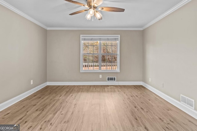 unfurnished room with visible vents, baseboards, and wood finished floors