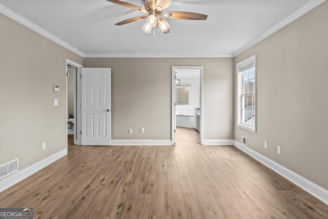 unfurnished bedroom with visible vents, crown molding, baseboards, and wood finished floors