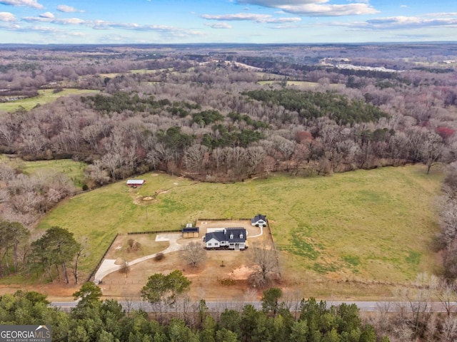 bird's eye view featuring a wooded view