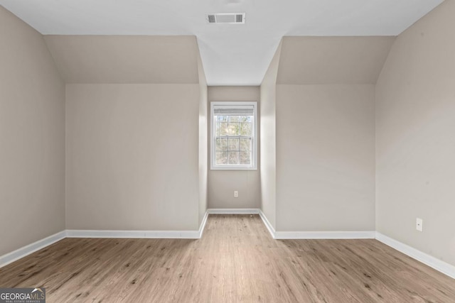 bonus room with visible vents, baseboards, and wood finished floors