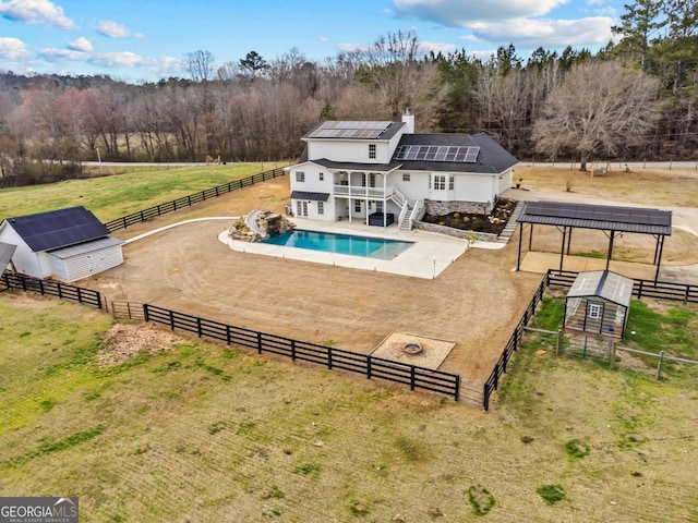 view of pool with fence, an enclosed area, and an outbuilding