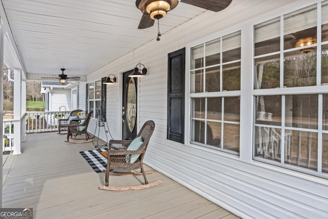 deck with ceiling fan and a porch