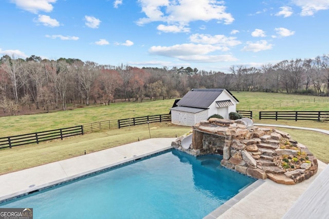 view of swimming pool with a fenced backyard, a fenced in pool, a lawn, and a rural view