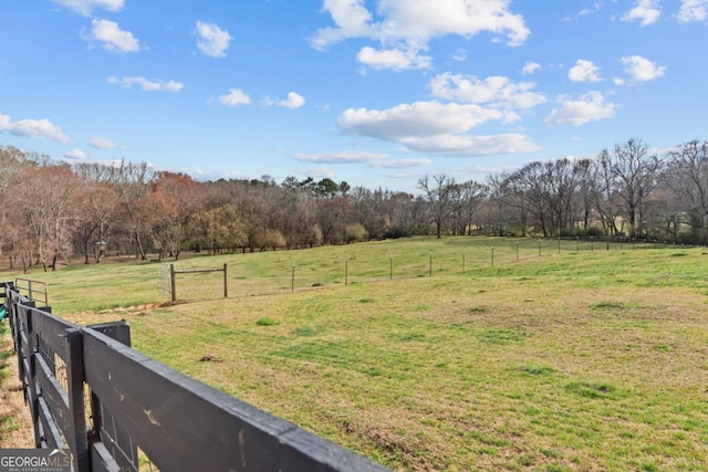 view of yard featuring a rural view and fence