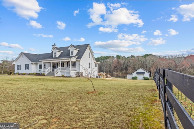 exterior space featuring covered porch, fence, and a front lawn