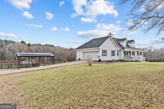 view of home's exterior with covered porch, a yard, fence, and driveway