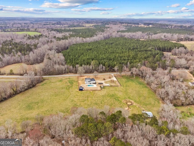 birds eye view of property featuring a wooded view