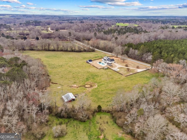 birds eye view of property featuring a rural view and a view of trees