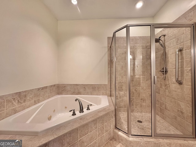 full bath featuring a whirlpool tub, a shower stall, and recessed lighting