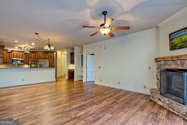 116 Smoky Mountain Ln Unit 103, Clayton, GA 30525 - unfurnished living room with dark wood finished floors, ornamental molding, a stone fireplace, ceiling fan, and recessed lighting